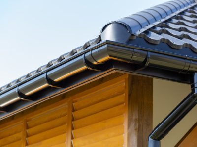 Corner of the new modern house with roof and gutter and wooden shutter